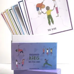 Open box of 84 illustrated kids yoga pose cards showing poses and teaching cues