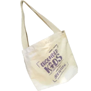 Grounded Kids Yoga branded canvas tote bag made by EcoBags, featuring sturdy handles and natural cotton fabric for carrying yoga supplies, teaching materials, or everyday items