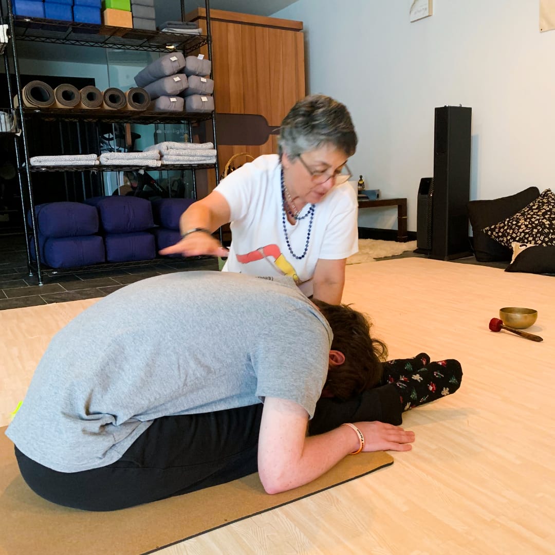 Jacob, a student with Down syndrome, autism, and cancer survivorship, seated calmly on his mat during kids yoga