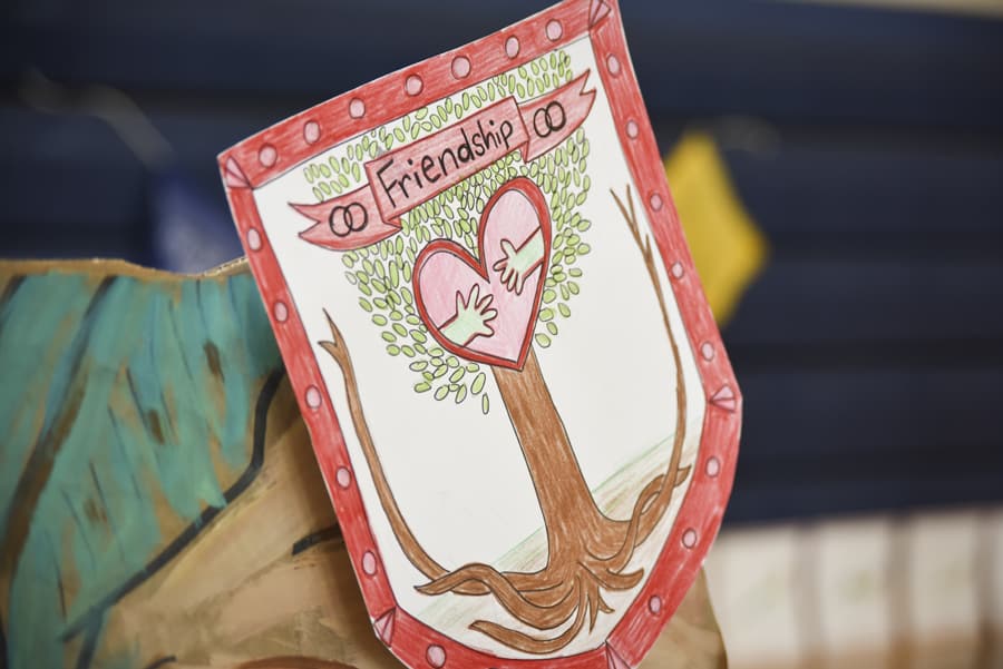 Hand-drawn coat of arms with a friendship tree holding a heart