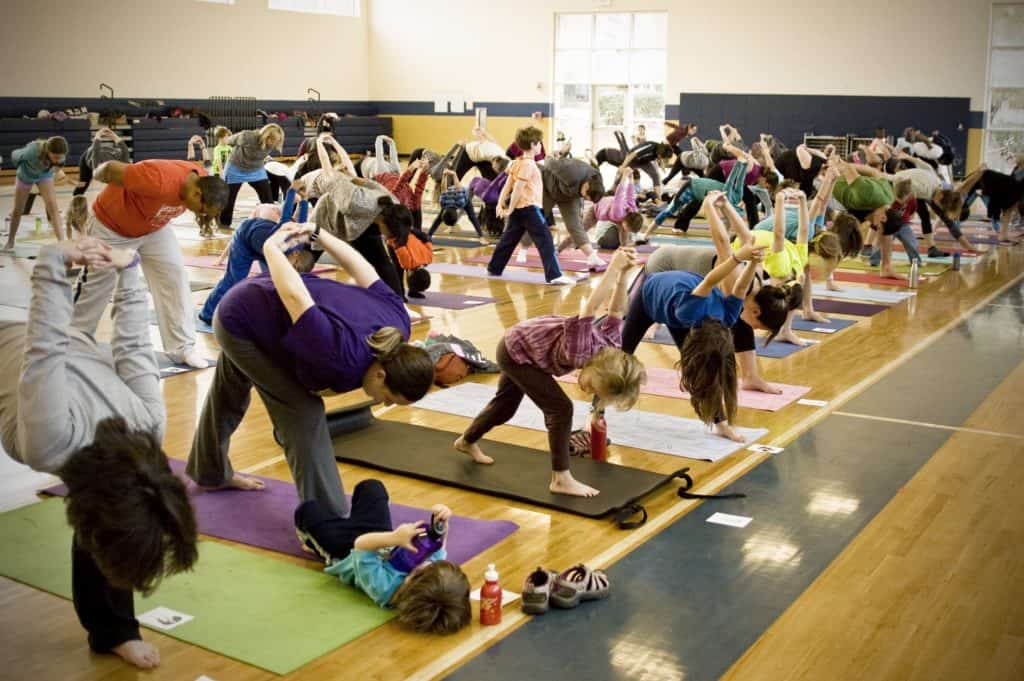 Families practicing Humble Warrior Pose during The One and Only Ivan yoga event to symbolize Stella the elephant’s wisdom and strength