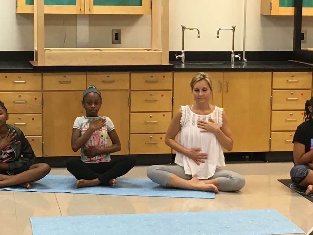 Grounded Kids Yoga teacher training participants in a summer intensive practicing poses together