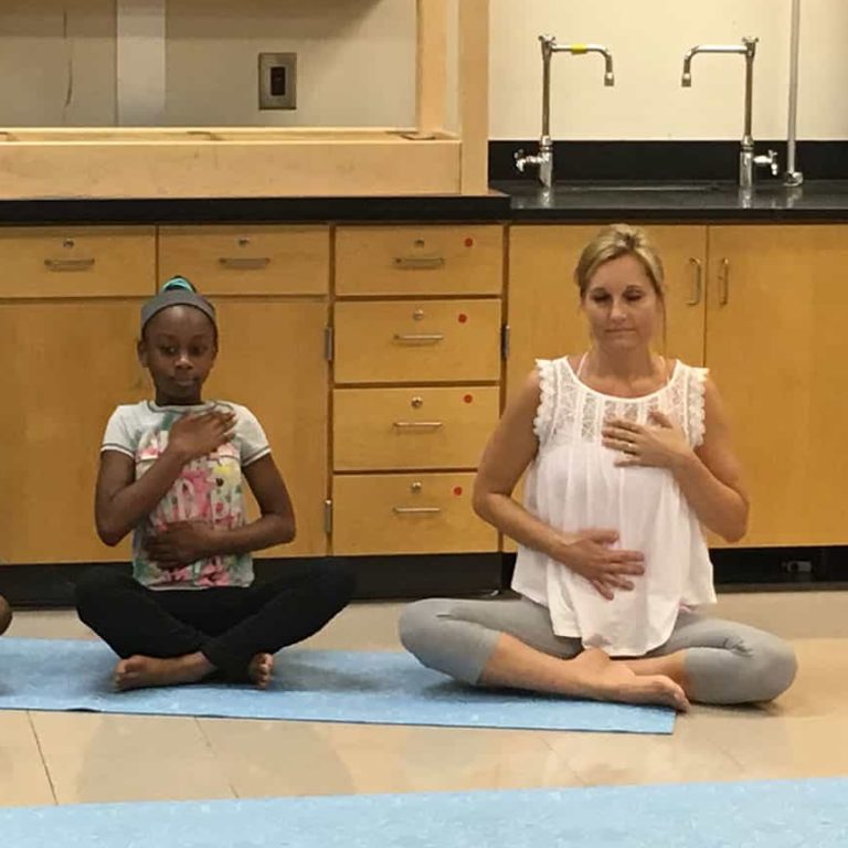 Grounded Kids Yoga teacher training participants in a summer intensive practicing poses together