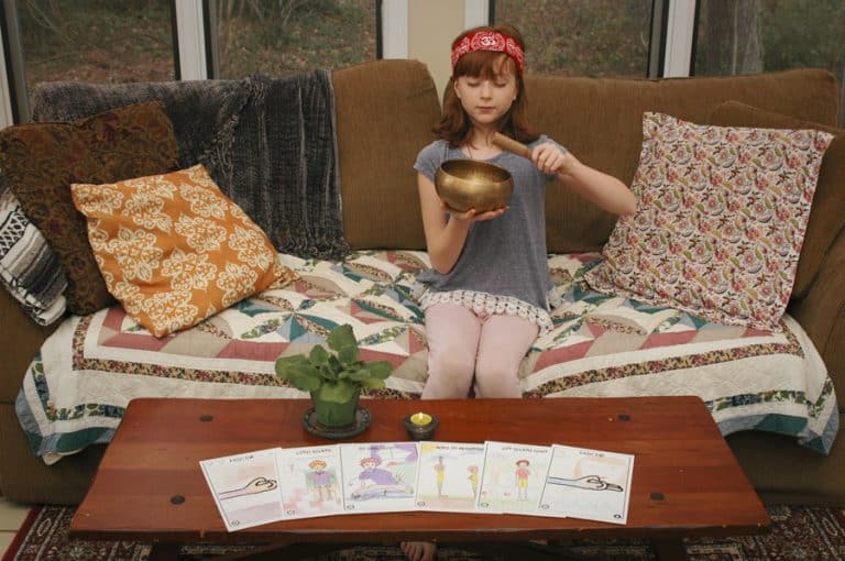 Child holding yoga bowl in focused pose from Focus 5