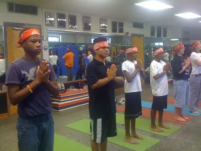 Child and instructor using Grounded Kids Yoga Elevator Series pose cards to practice balancing and grounding postures together